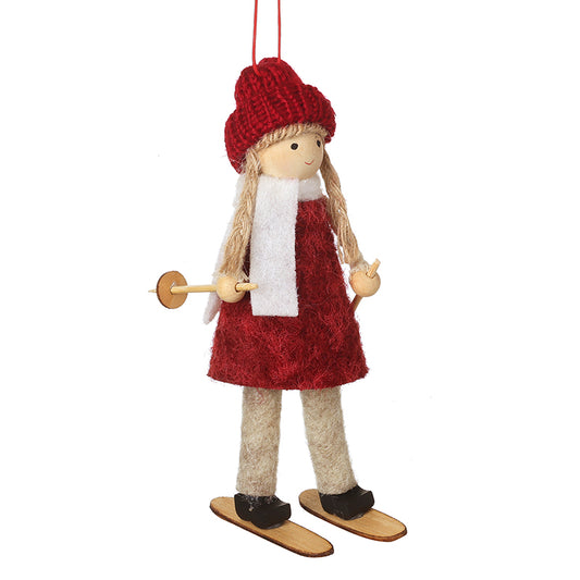 HANGING GIRL IN RED HAT & DRESS ON SKIS