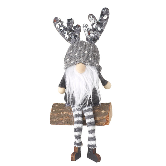 Grey Gonk With Sequins Sitting On Log